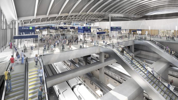 Interior aerial view of Old Oak Common station concourse, with escaltors descending to railway platforms.