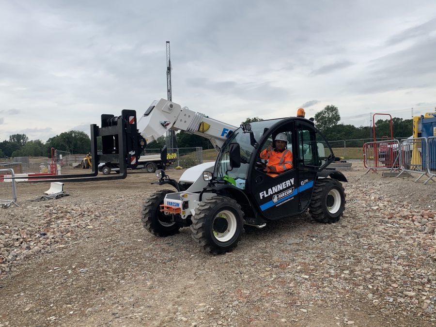 electric forklift telehandler on a construction site.