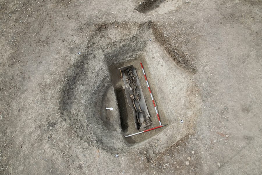 Archaeological excavation revealing a skeleton in a lead coffin.