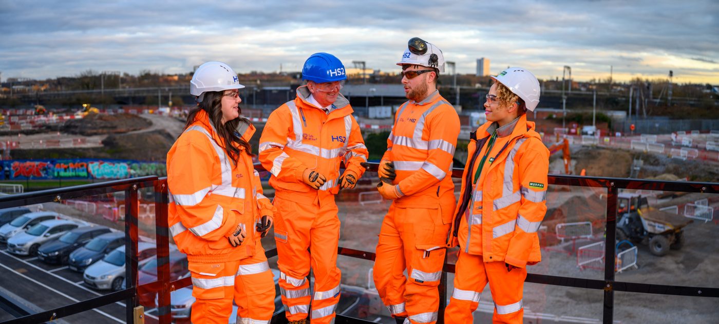 Four people in high vis talking