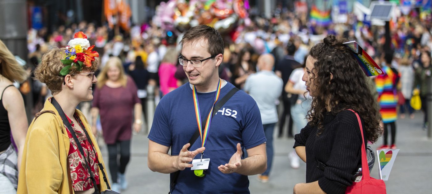 A HS2 staff member talking with two members of the general public