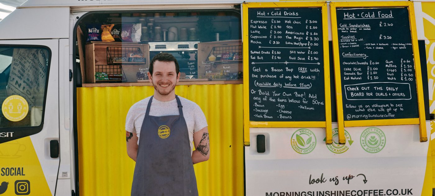 A man standing in front of a food truck