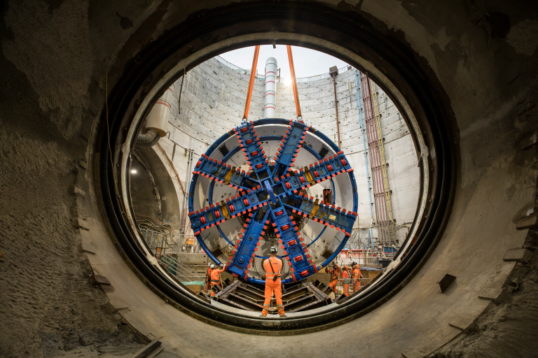 Engineers guide the giant cutterhead for one of HS2's tunnel boring machines (TBM) into place, 25 metres below ground.