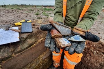 Thumbnail 4 of An archaeologist showing post medieval pottery from the Coleshill Manor site.